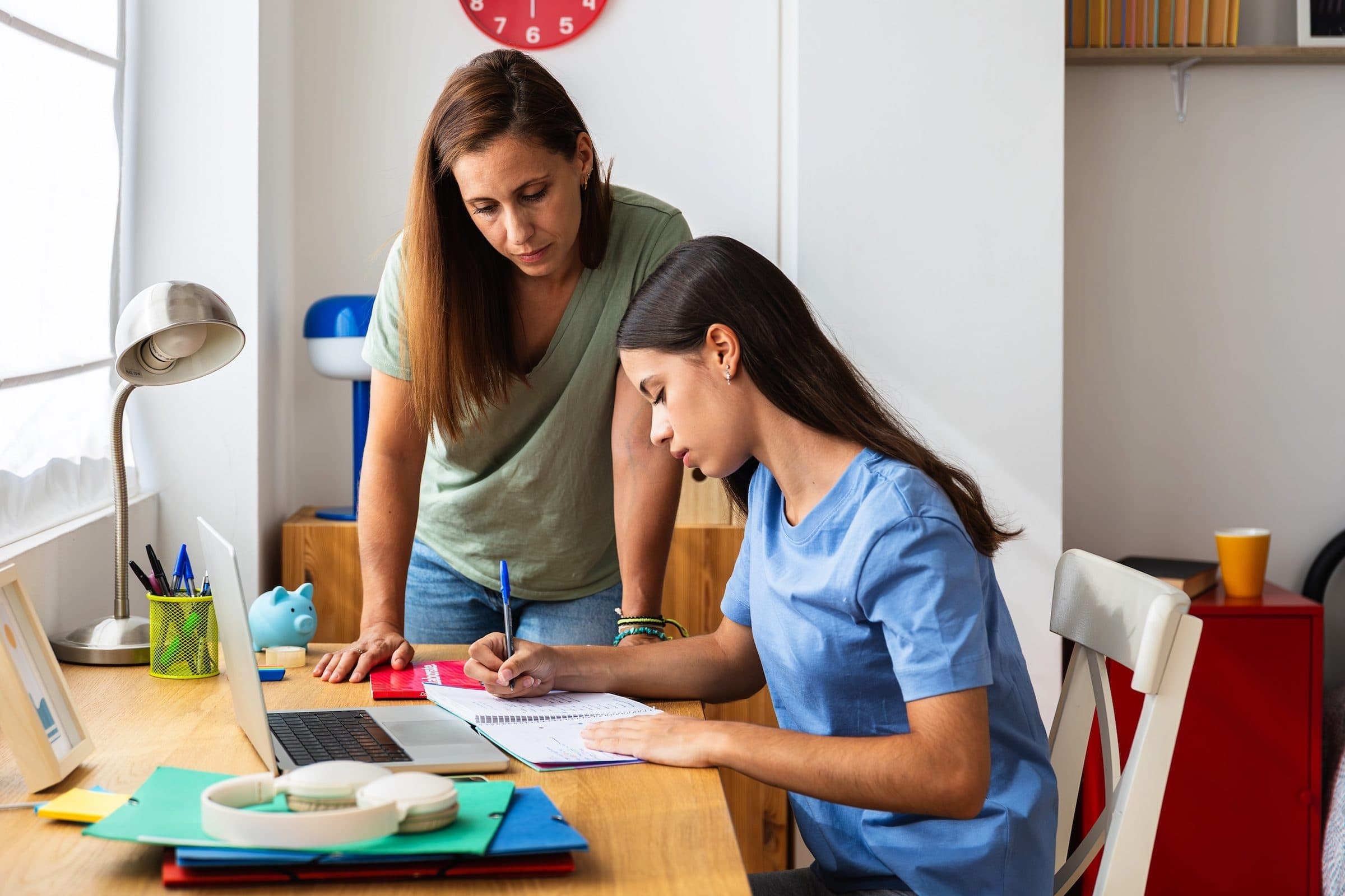 A parent and student learning together at home