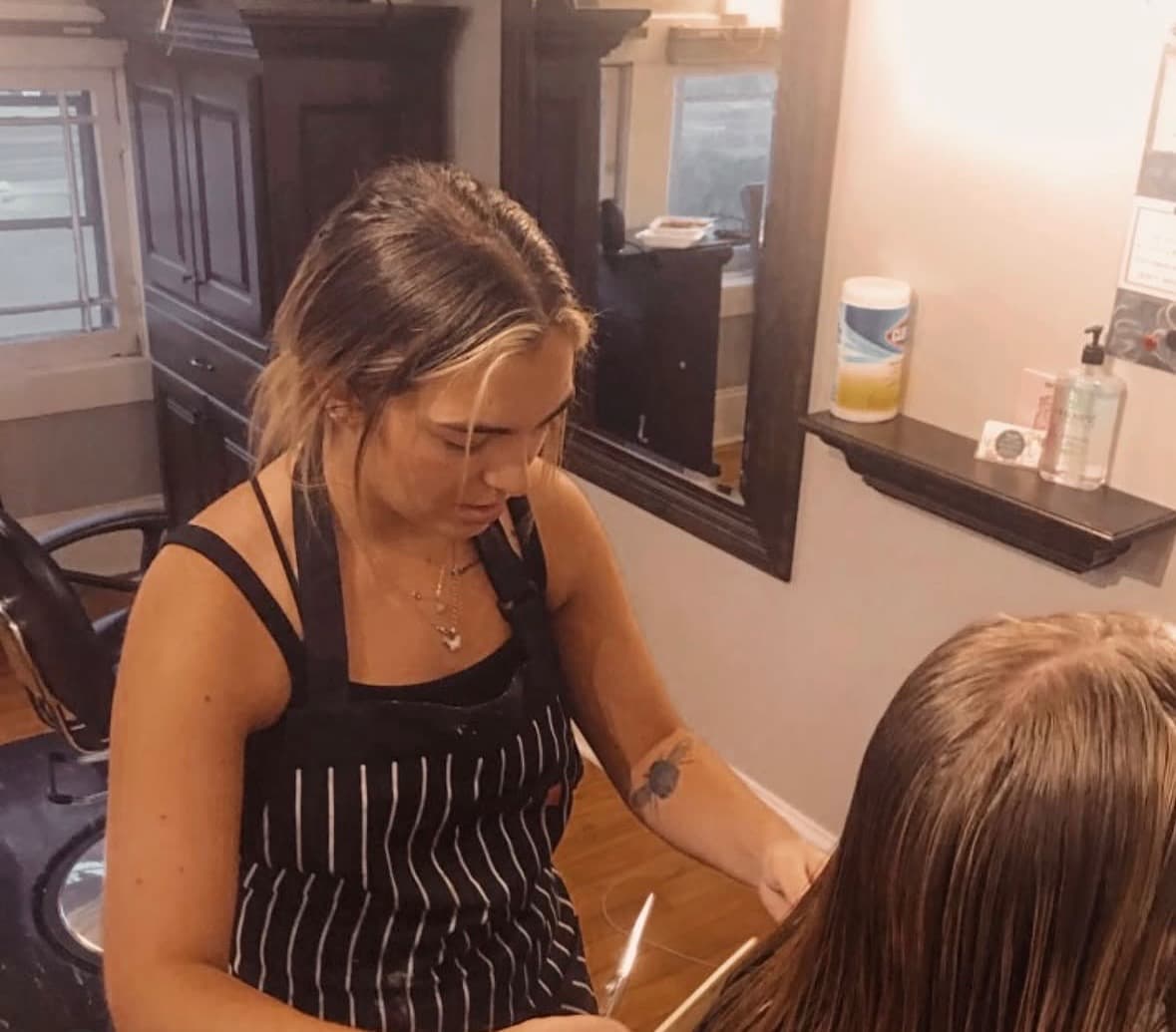 Maddie working with a client at a salon station